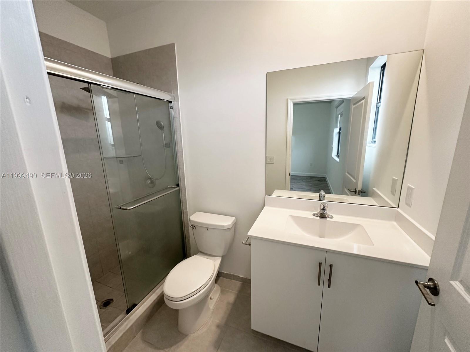 949 Northeast 211th Street Miami, FL 33179 - Photo 18 of 27 a bathroom with a sink toilet and shower