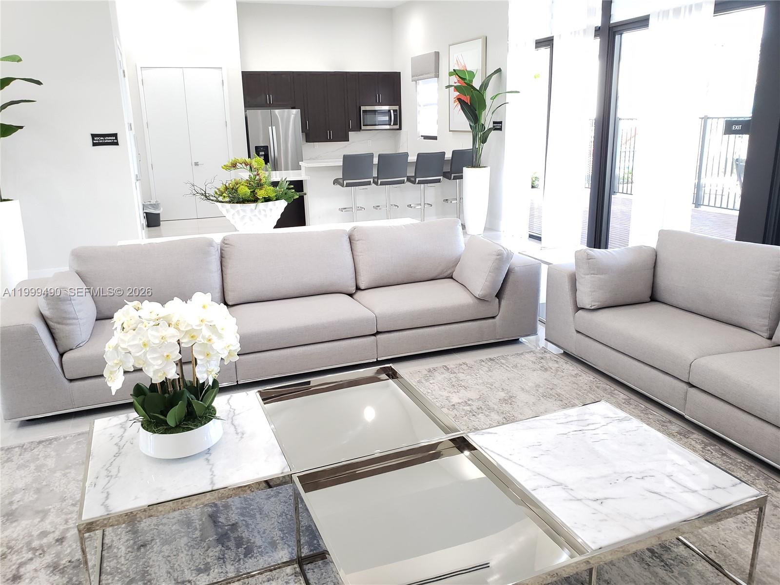 949 Northeast 211th Street Miami, FL 33179 - Photo 24 of 27 a living room with furniture flowerpot and a chandelier