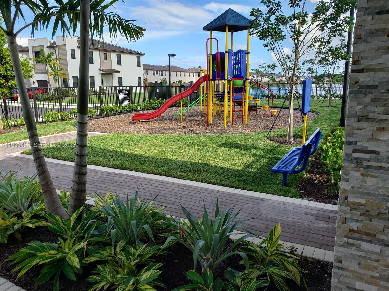 949 Northeast 211th Street Miami, FL 33179 - Photo 25 of 27 a view of a park with swings and slides