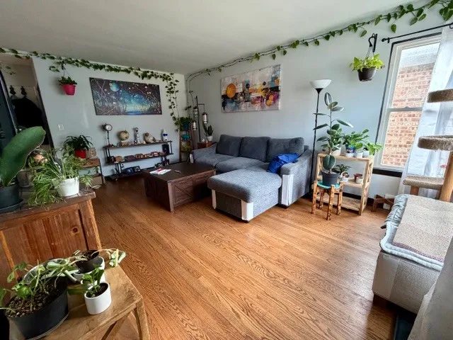 a living room with furniture and flowers