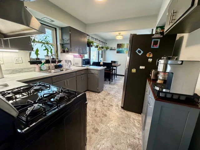 a kitchen with a stove and a refrigerator