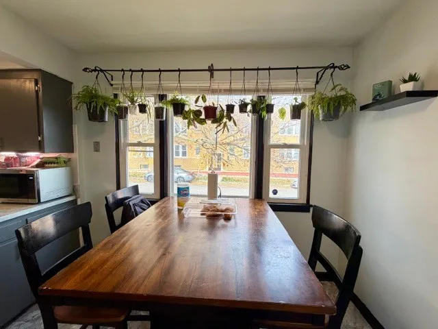 a dining room with a table chairs and entryway