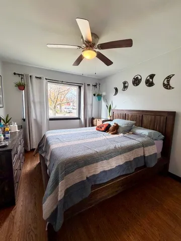 a bedroom with a bed a window and dresser