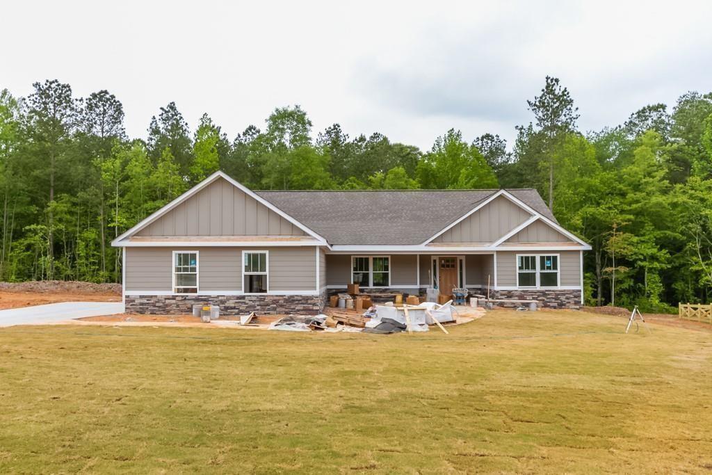 a front view of house with yard and swimming pool