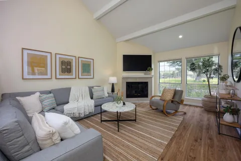 a living room with furniture fireplace and a flat screen tv