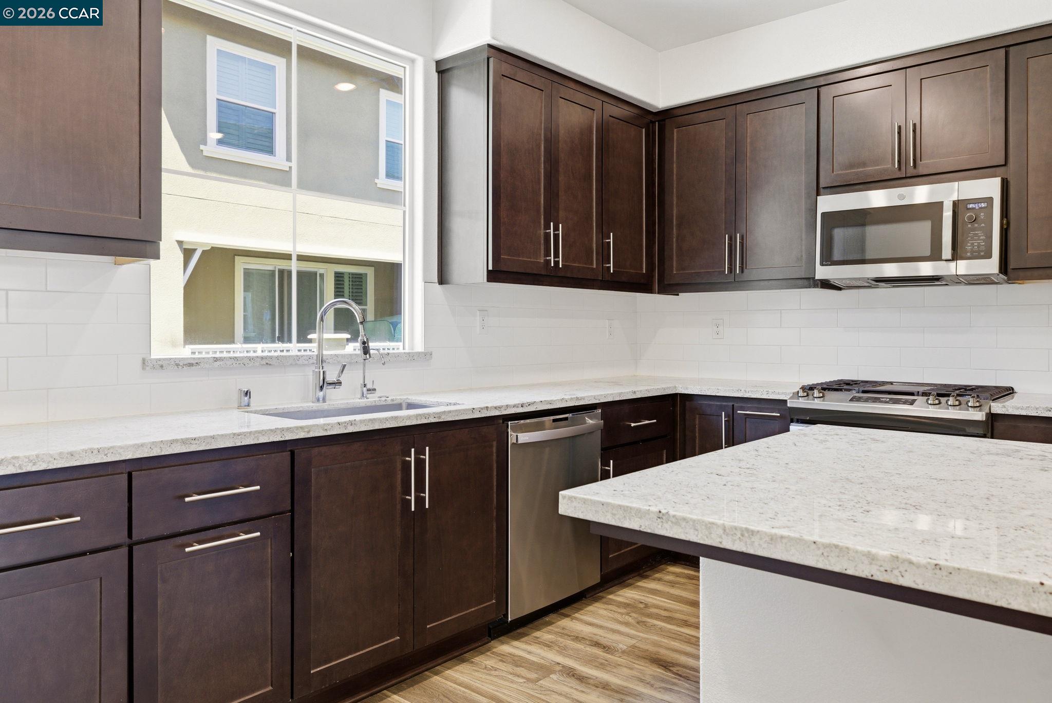 205 Plum Tree Street Livermore, CA 94551 - Photo 18 of 47 a kitchen with a sink and a microwave