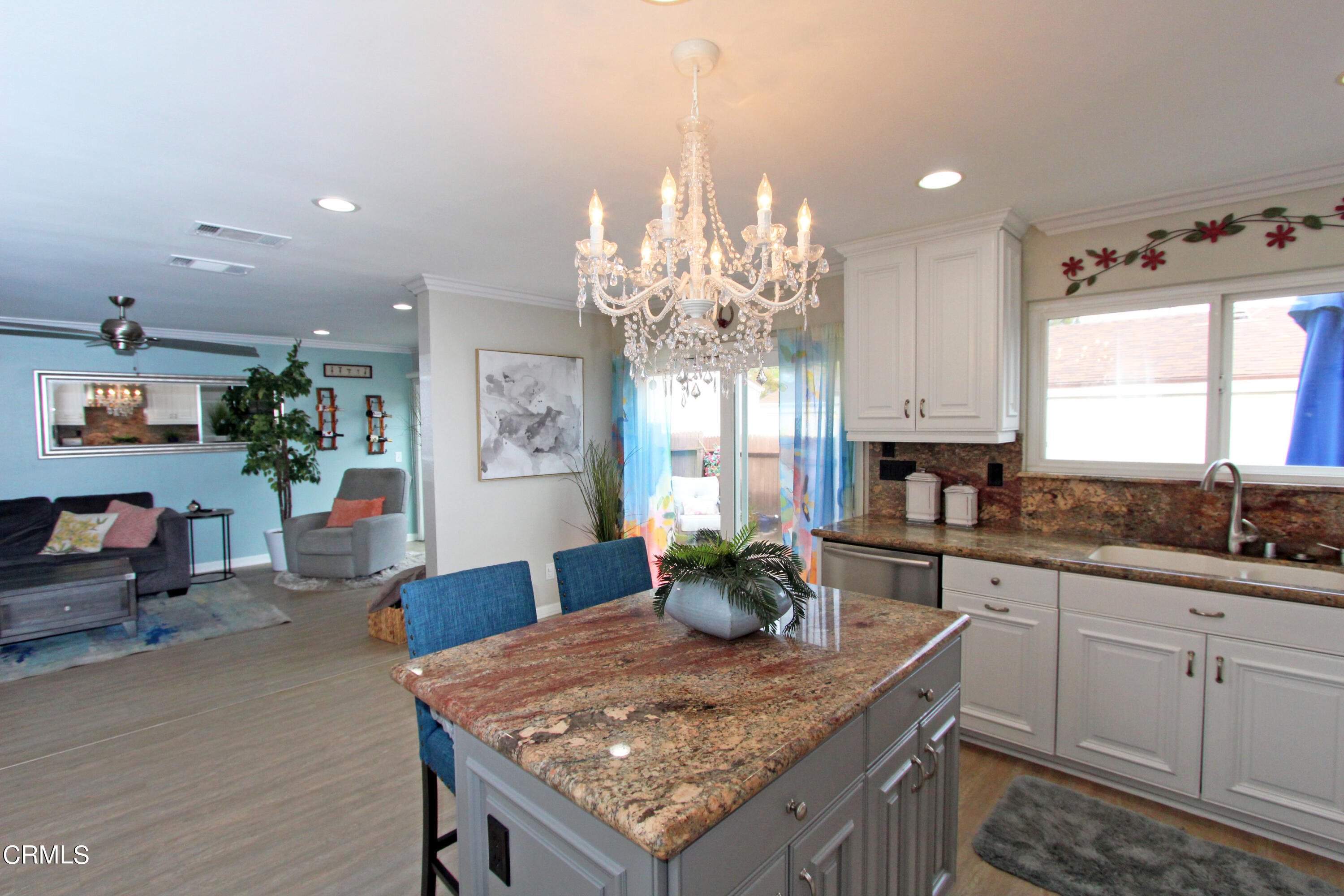 15030 Reedley Street, Unit C Moorpark, CA 93021 - Photo 12 of 51 a kitchen with stainless steel appliances granite countertop a sink stove and cabinets