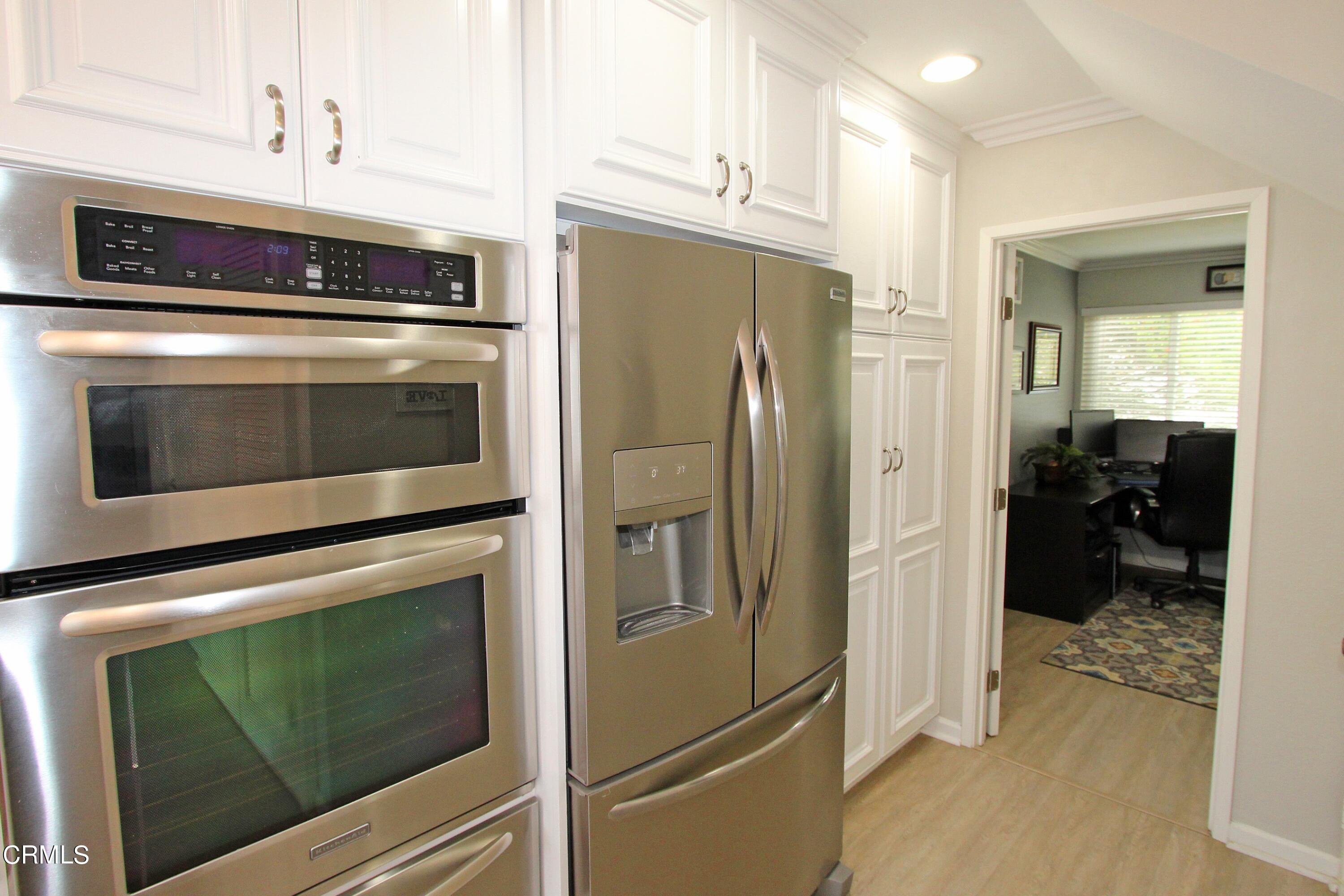 15030 Reedley Street, Unit C Moorpark, CA 93021 - Photo 16 of 51 a kitchen with cabinets and stainless steel appliances