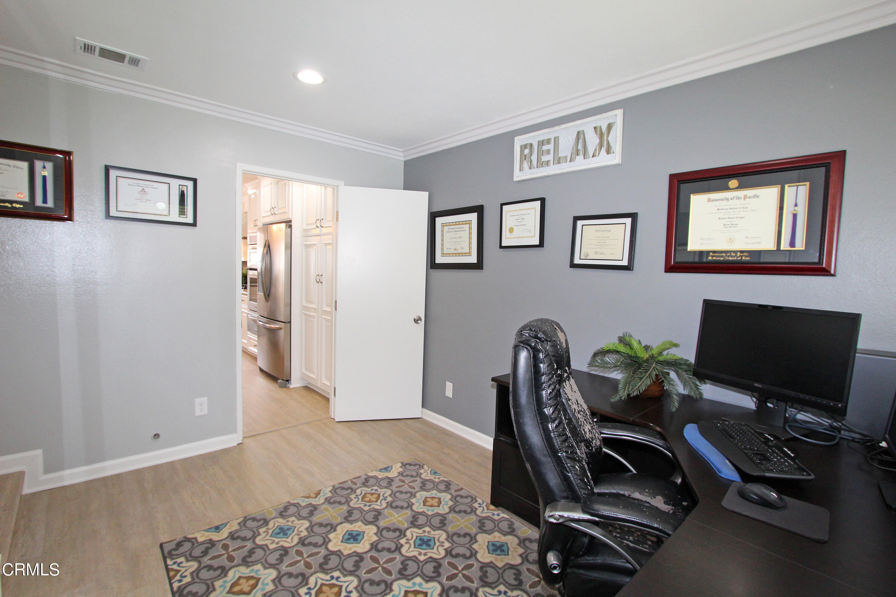 15030 Reedley Street, Unit C Moorpark, CA 93021 - Photo 18 of 51 a view of a workspace with furniture and a flat screen tv
