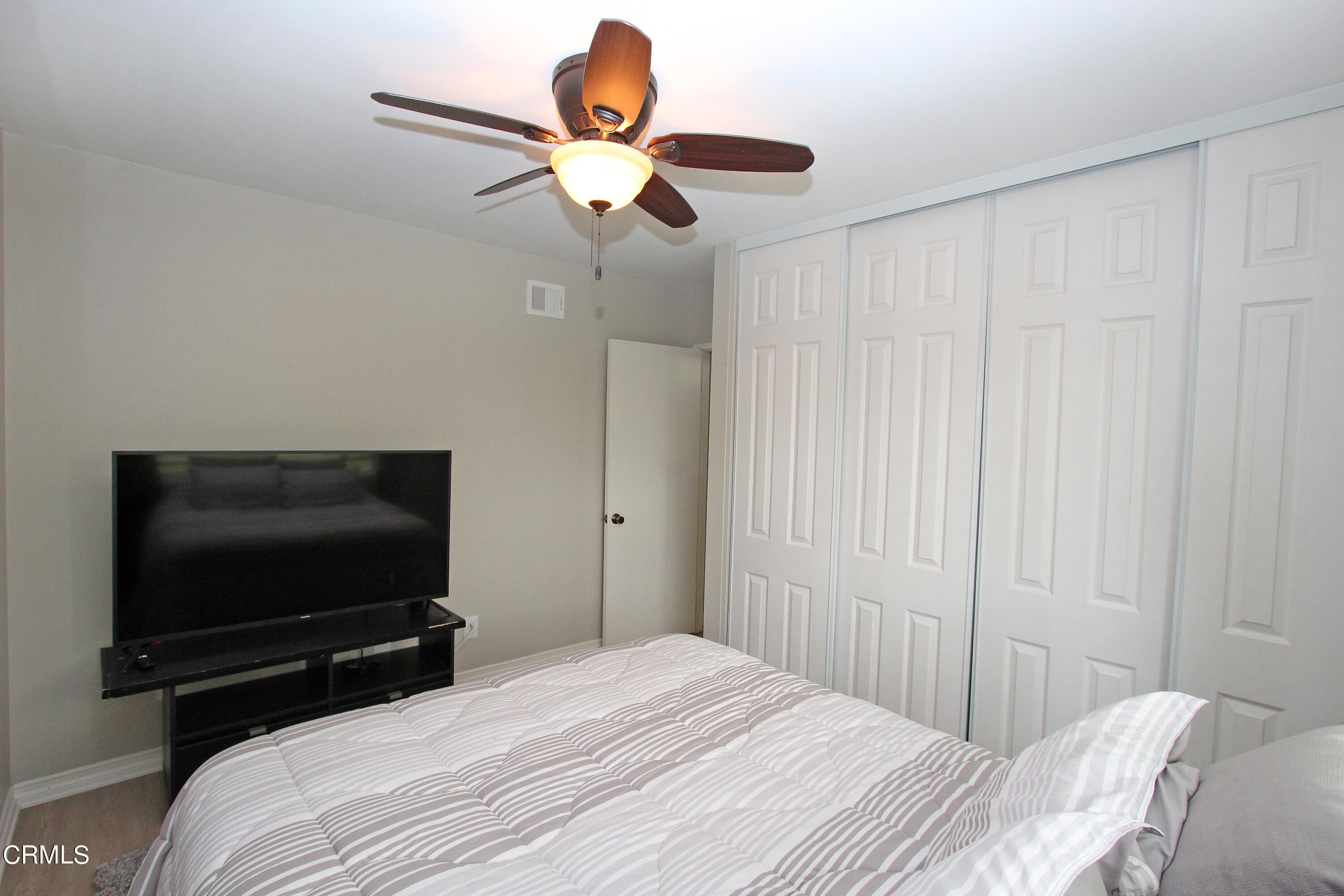15030 Reedley Street, Unit C Moorpark, CA 93021 - Photo 26 of 51 a bedroom with a bed and a flat screen tv