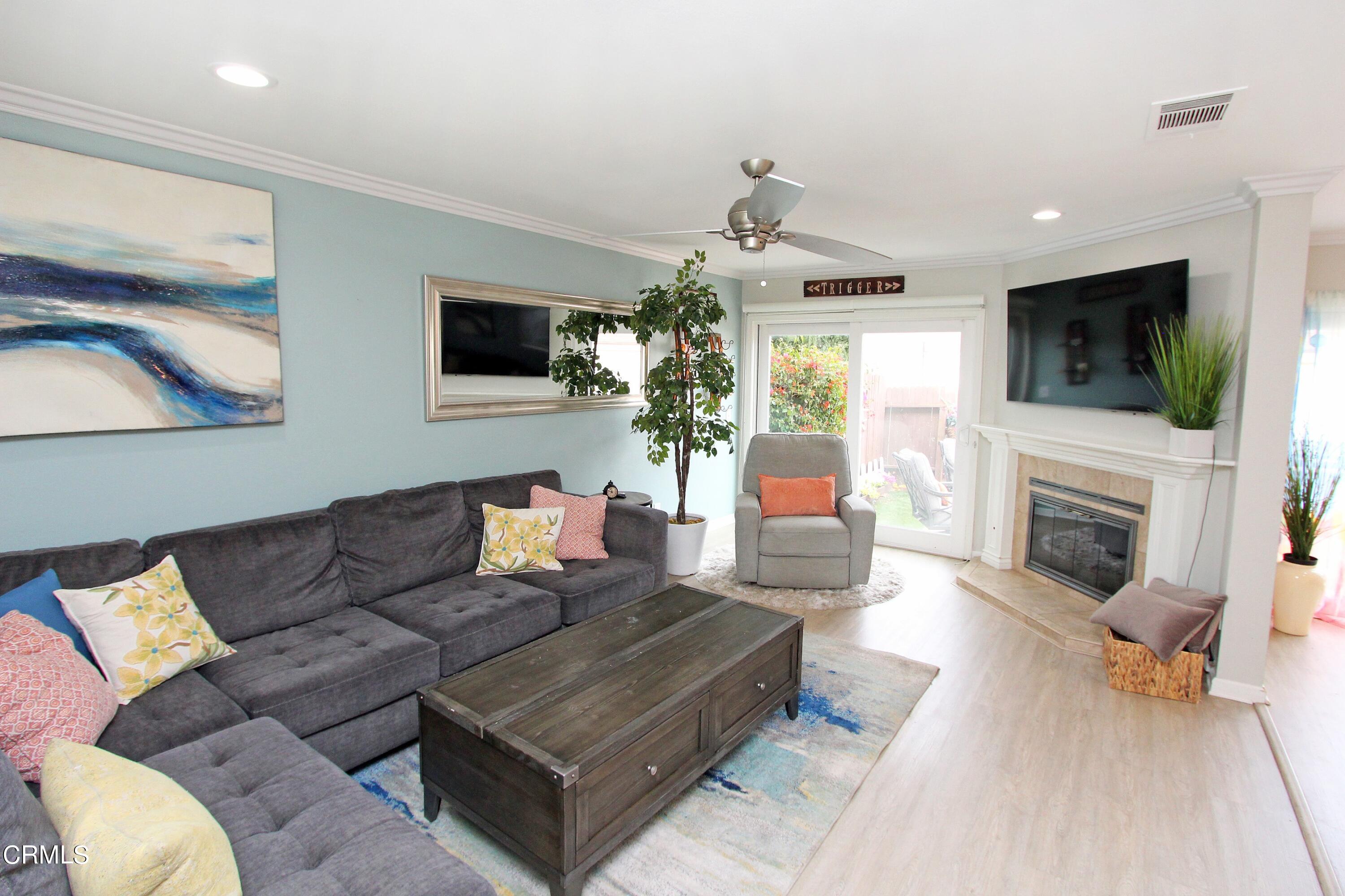 15030 Reedley Street, Unit C Moorpark, CA 93021 - Photo 4 of 51 a living room with furniture a flat screen tv and a fireplace