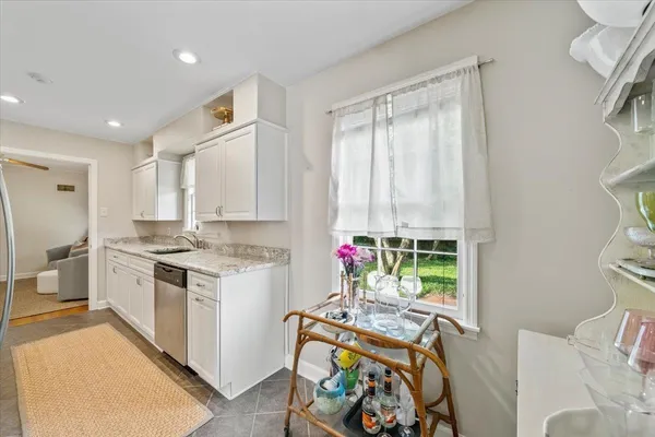 a kitchen with stove and white cabinets