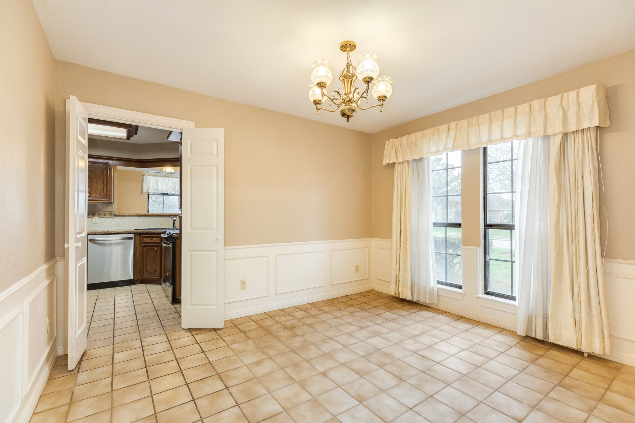 212 Any Way Street Lake Jackson, TX 77566 - Photo 11 of 28 a view of a big room with windows and chandelier