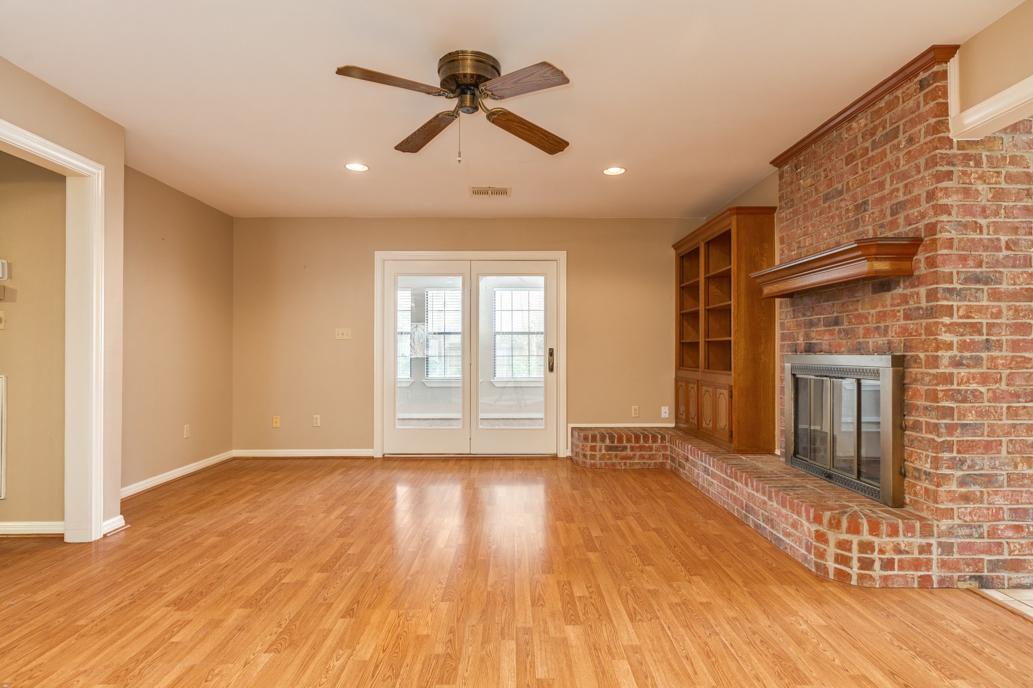 212 Any Way Street Lake Jackson, TX 77566 - Photo 13 of 28 a view of empty room with wooden floor and fan