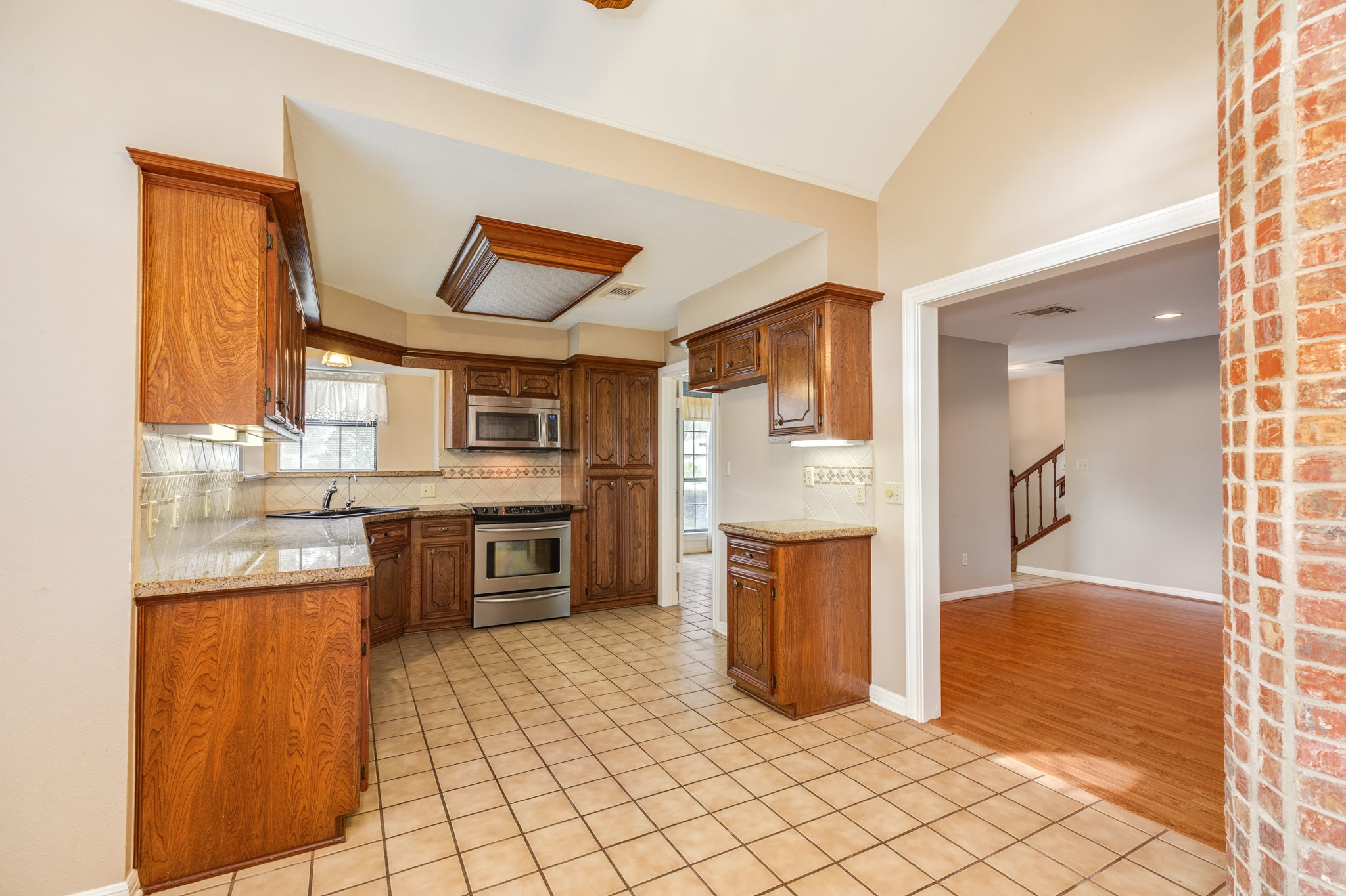 212 Any Way Street Lake Jackson, TX 77566 - Photo 15 of 28 a large kitchen with cabinets and stainless steel appliances