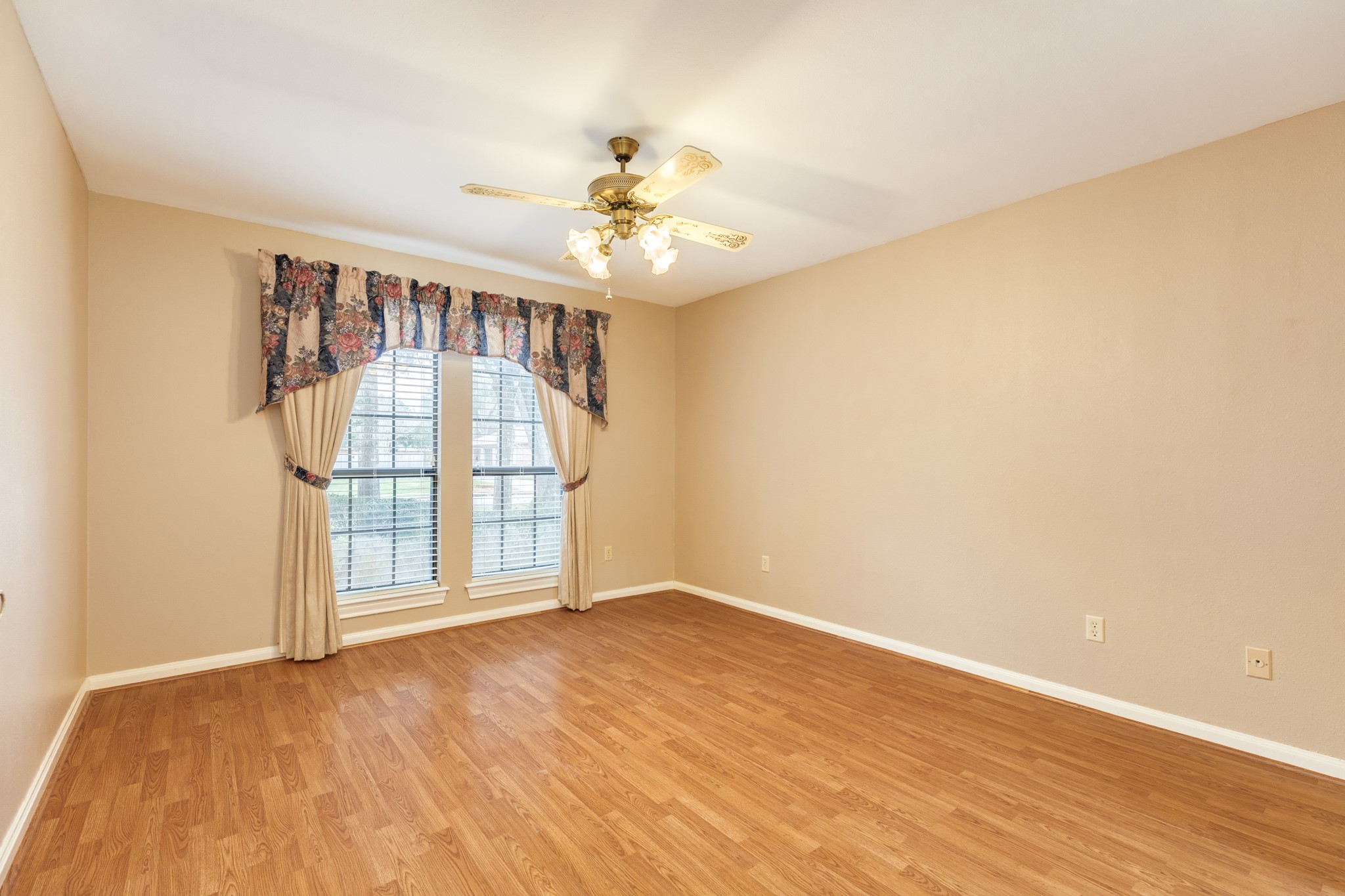 212 Any Way Street Lake Jackson, TX 77566 - Photo 17 of 28 wooden floor in an empty room with a window