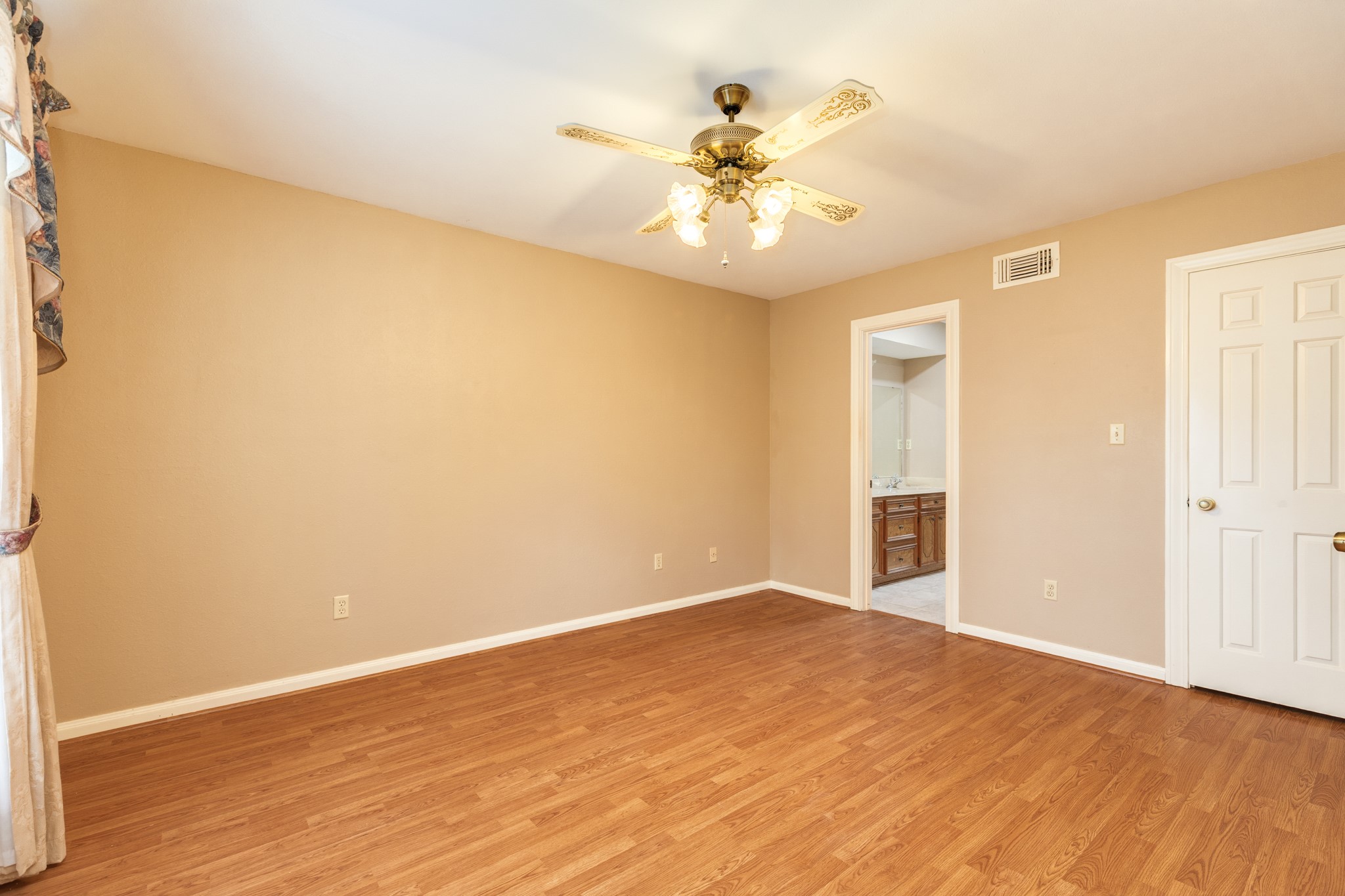 212 Any Way Street Lake Jackson, TX 77566 - Photo 18 of 28 a view of an empty room with wooden floor and a ceiling fan