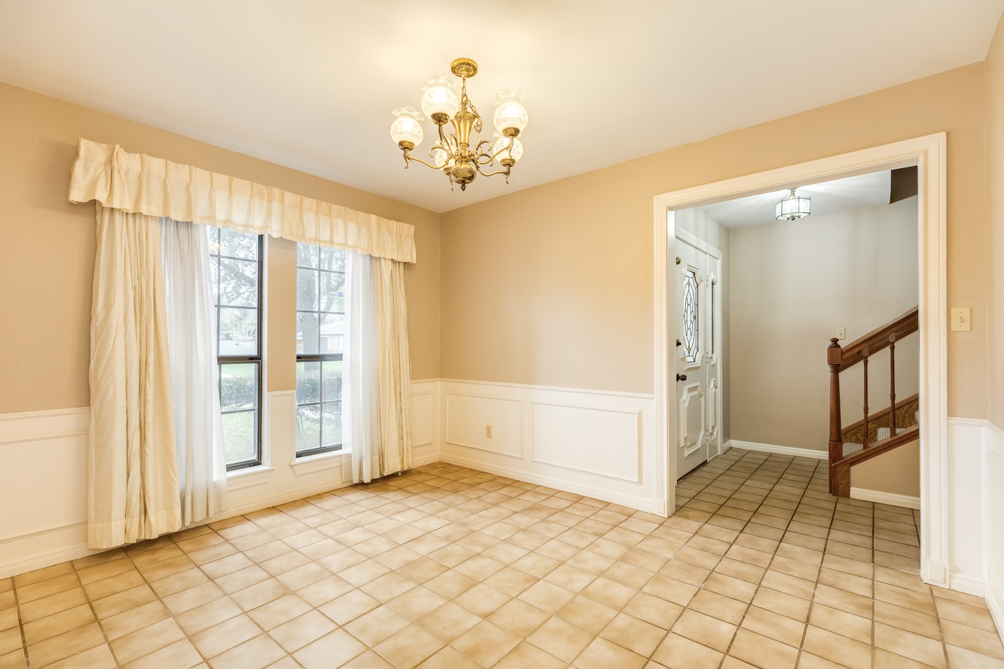 212 Any Way Street Lake Jackson, TX 77566 - Photo 4 of 28 a view of a big room with windows and chandelier