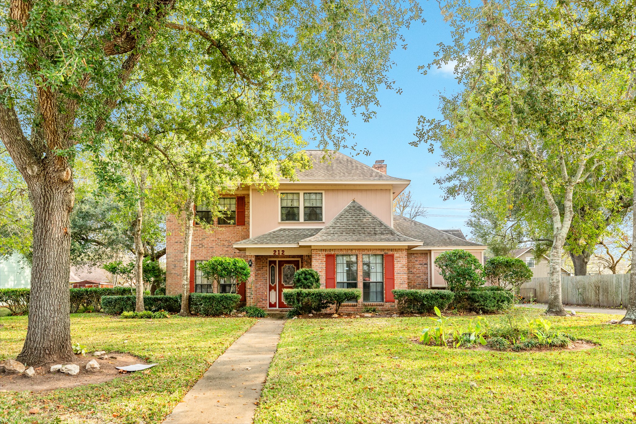 212 Any Way Street Lake Jackson, TX 77566 - Photo 7 of 28 a front view of a house with a yard
