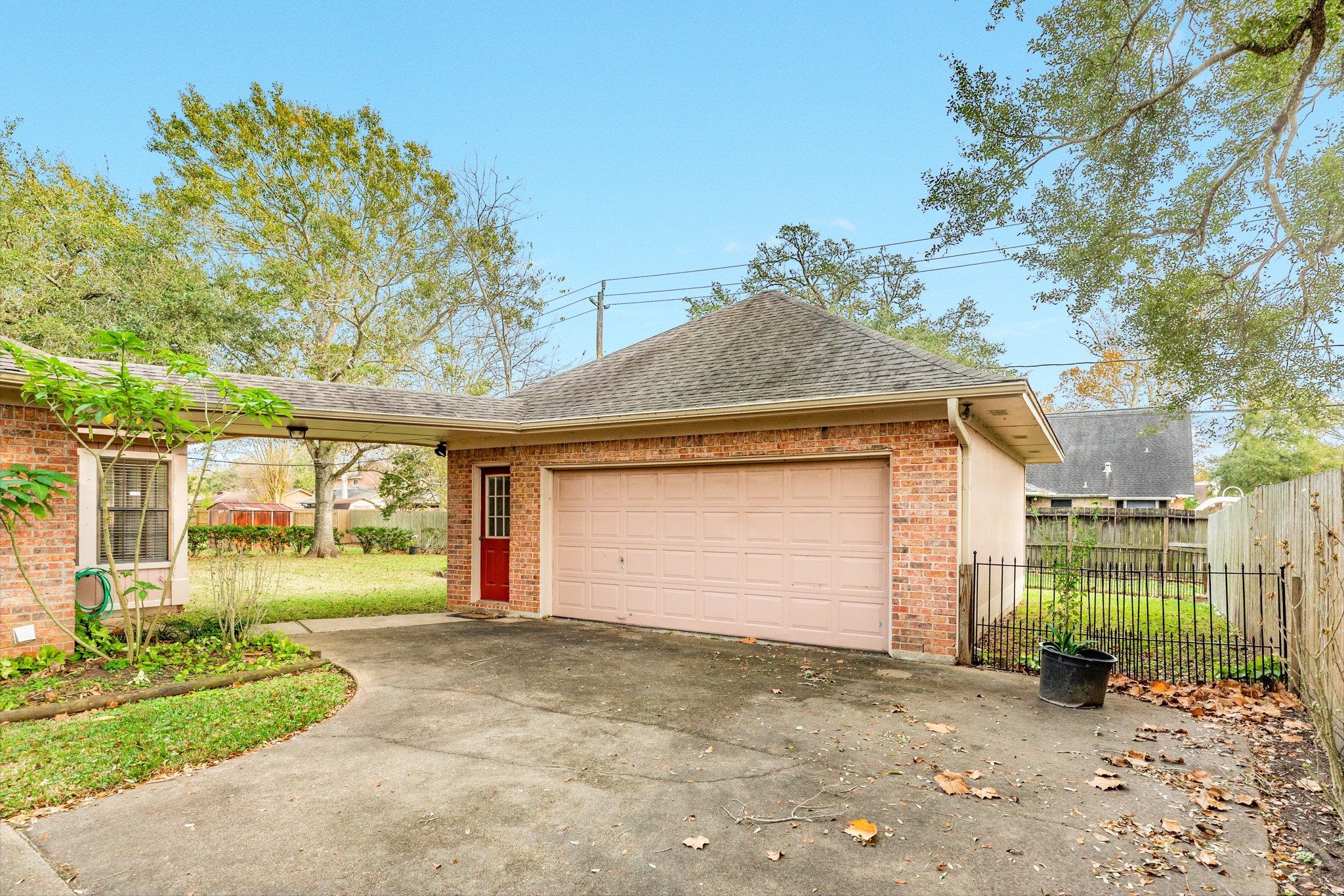 212 Any Way Street Lake Jackson, TX 77566 - Photo 9 of 28 a front view of a house with a yard and garage