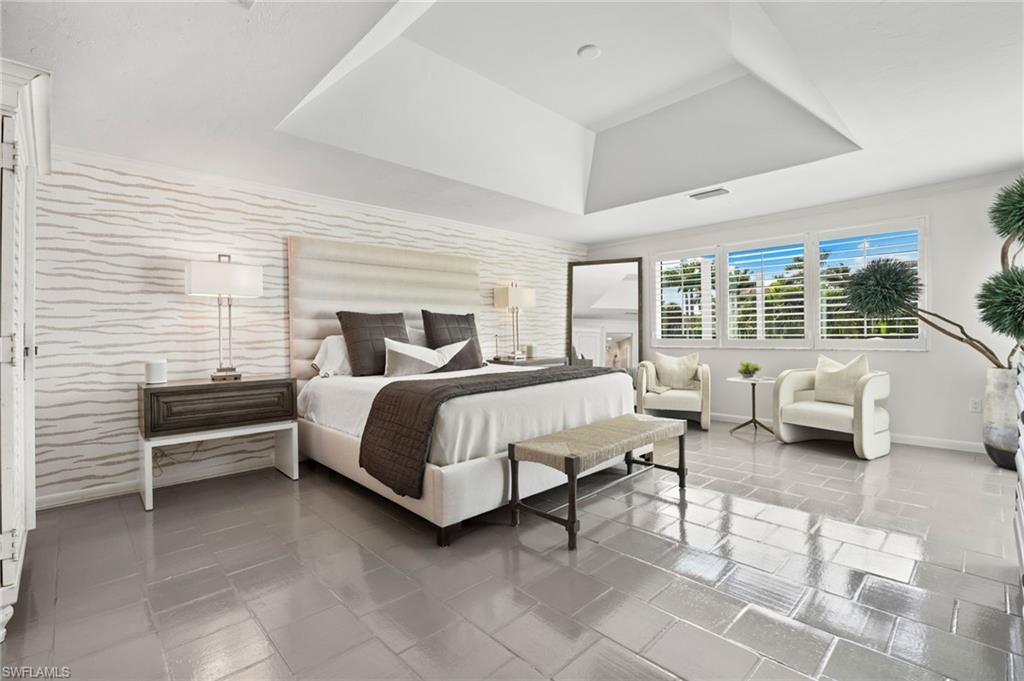 3737 Crayton Road Naples, FL 34103 - Photo 12 of 33 a bedroom with a bed couch and a window