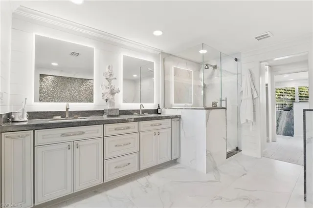 a bathroom with a granite countertop sink mirror and double