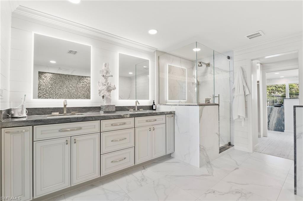 3737 Crayton Road Naples, FL 34103 - Photo 13 of 33 a bathroom with a granite countertop sink mirror and double