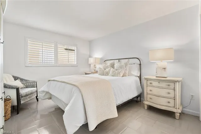 a bedroom with a bed and chair