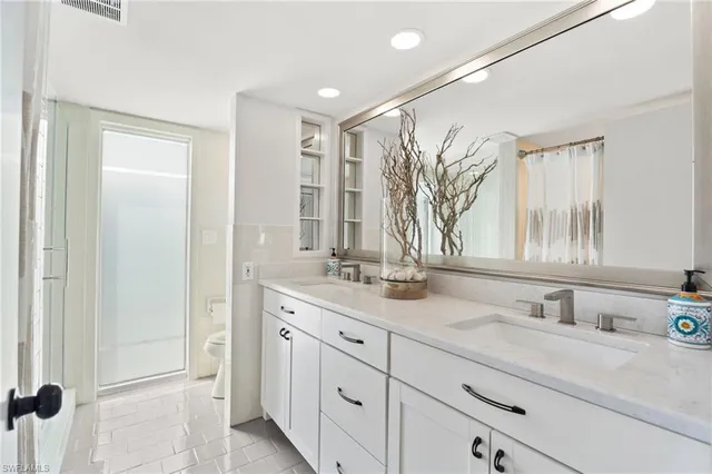 a bathroom with a double vanity sink and a mirror
