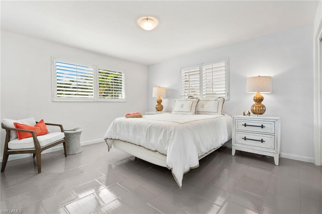 3737 Crayton Road Naples, FL 34103 - Photo 21 of 33 a bedroom with bed and window