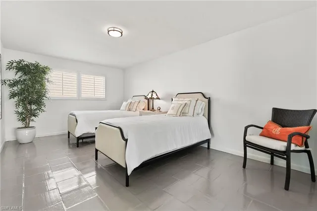 a bedroom with a bed and a chair