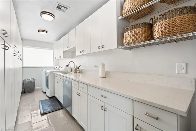 a kitchen with a sink cabinets and window