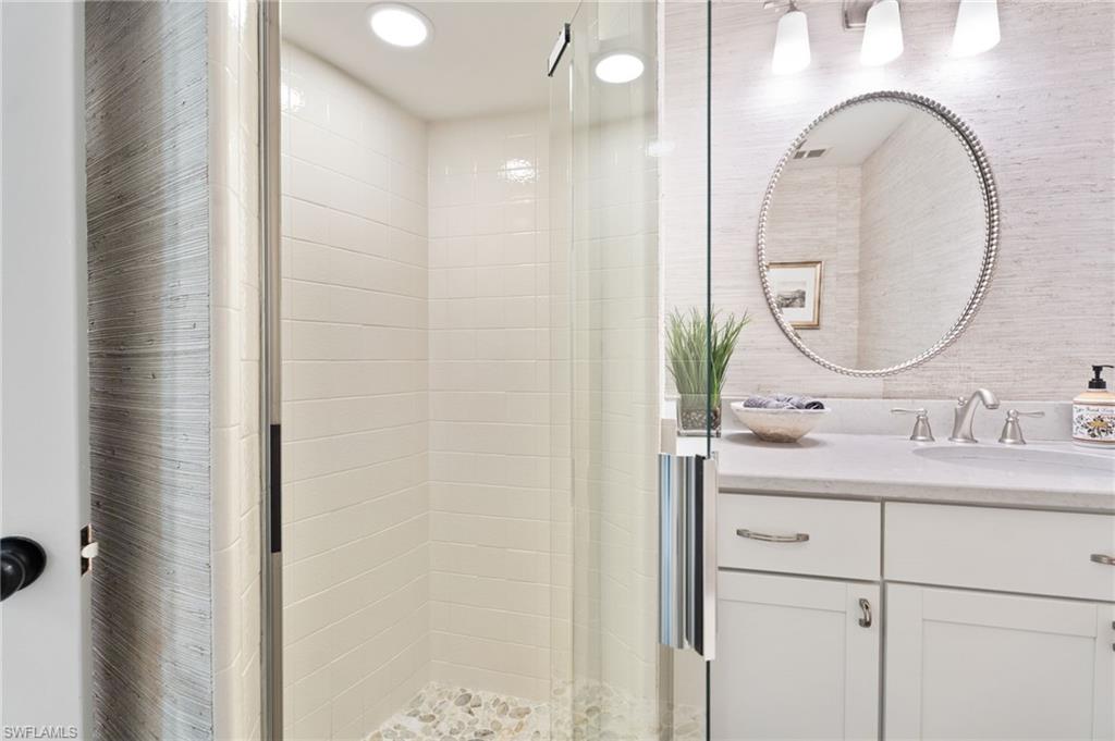 3737 Crayton Road Naples, FL 34103 - Photo 24 of 33 a bathroom with a sink and a mirror