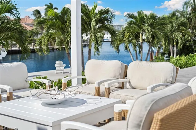 a view of a dining room with furniture and a potted plant