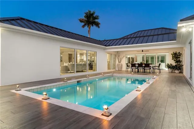 a view of a swimming pool with outdoor seating