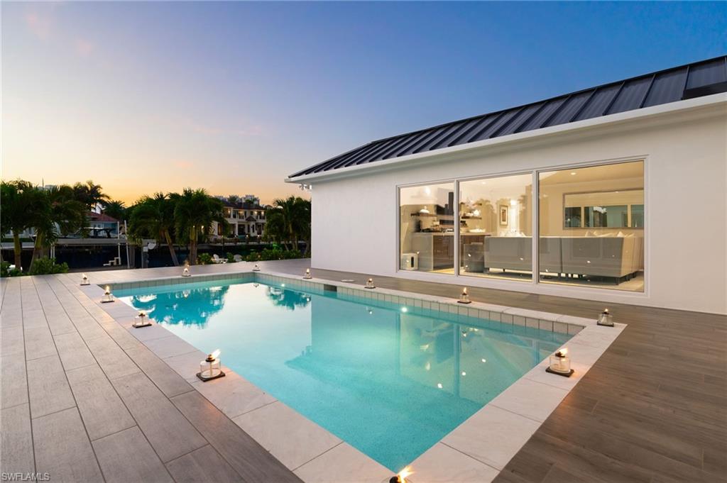 3737 Crayton Road Naples, FL 34103 - Photo 5 of 33 a view of swimming pool with lounge chair