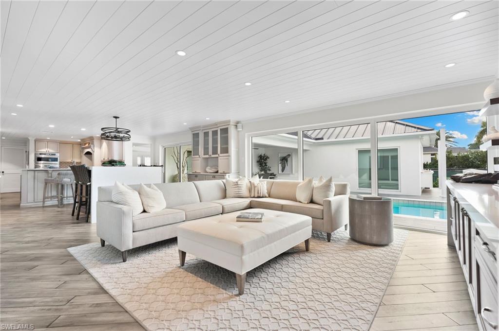 3737 Crayton Road Naples, FL 34103 - Photo 6 of 33 a living room with furniture and a table