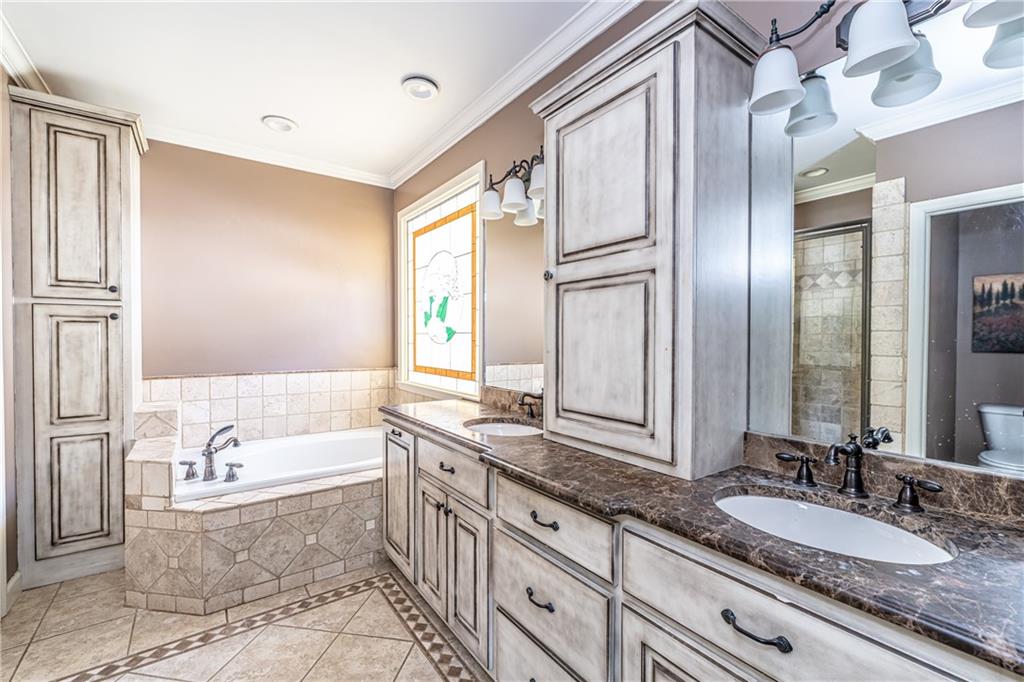 113 Warwick Way Rome, GA 30161 - Photo 22 of 49 a spacious bathroom with a granite countertop tub sink and mirror