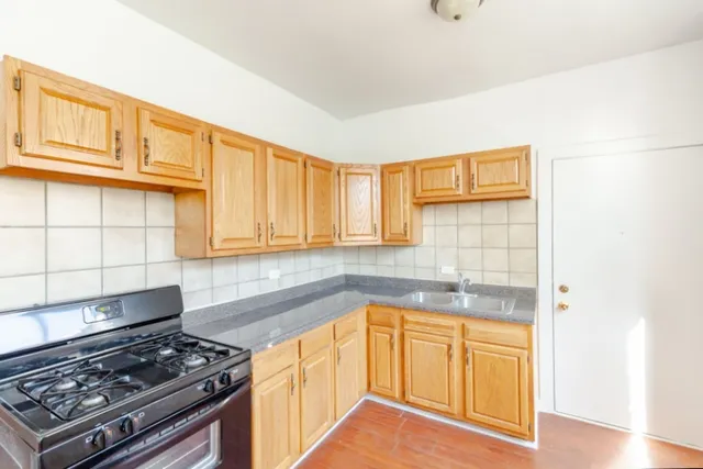 a kitchen with wooden cabinets and a stove top oven