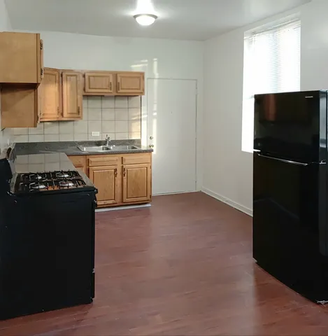 a kitchen with a refrigerator stove and sink