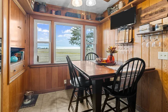 a view of a dining room with furniture a chandelier and wooden floor