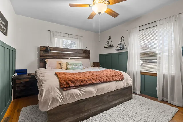 a bedroom with a bed and a chandelier