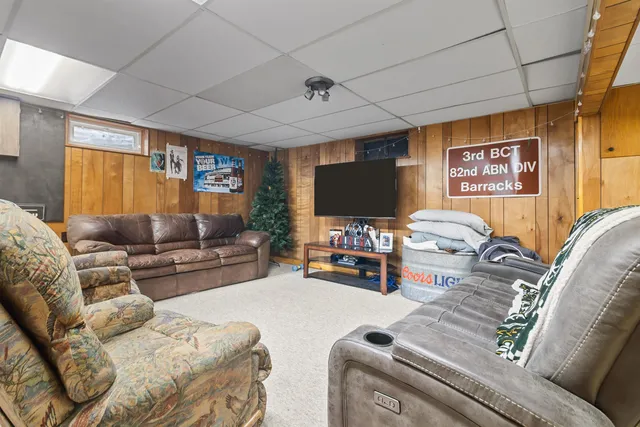 a bed room with furniture and a flat screen tv
