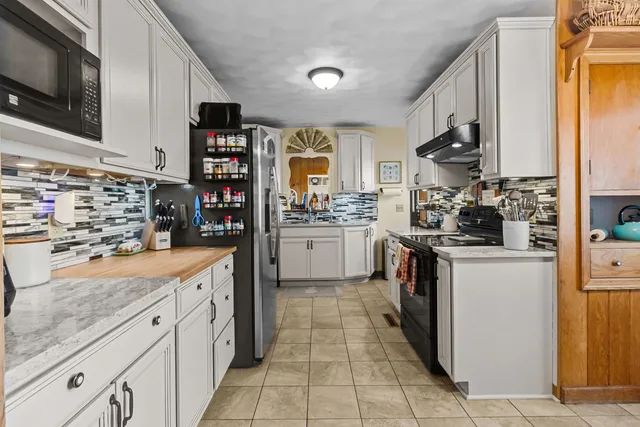 a kitchen with stainless steel appliances granite countertop a sink and a stove