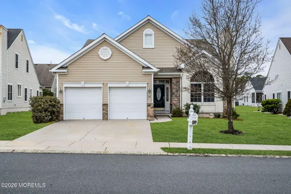 a front view of house with yard and green space