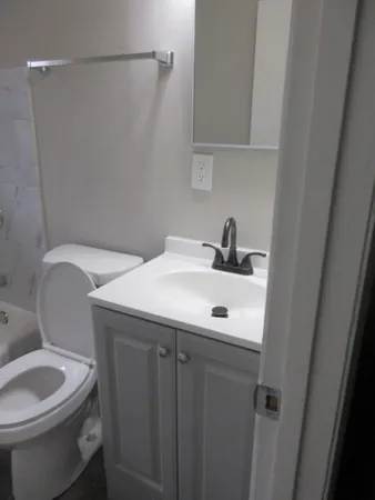 a bathroom with a toilet and bathtub