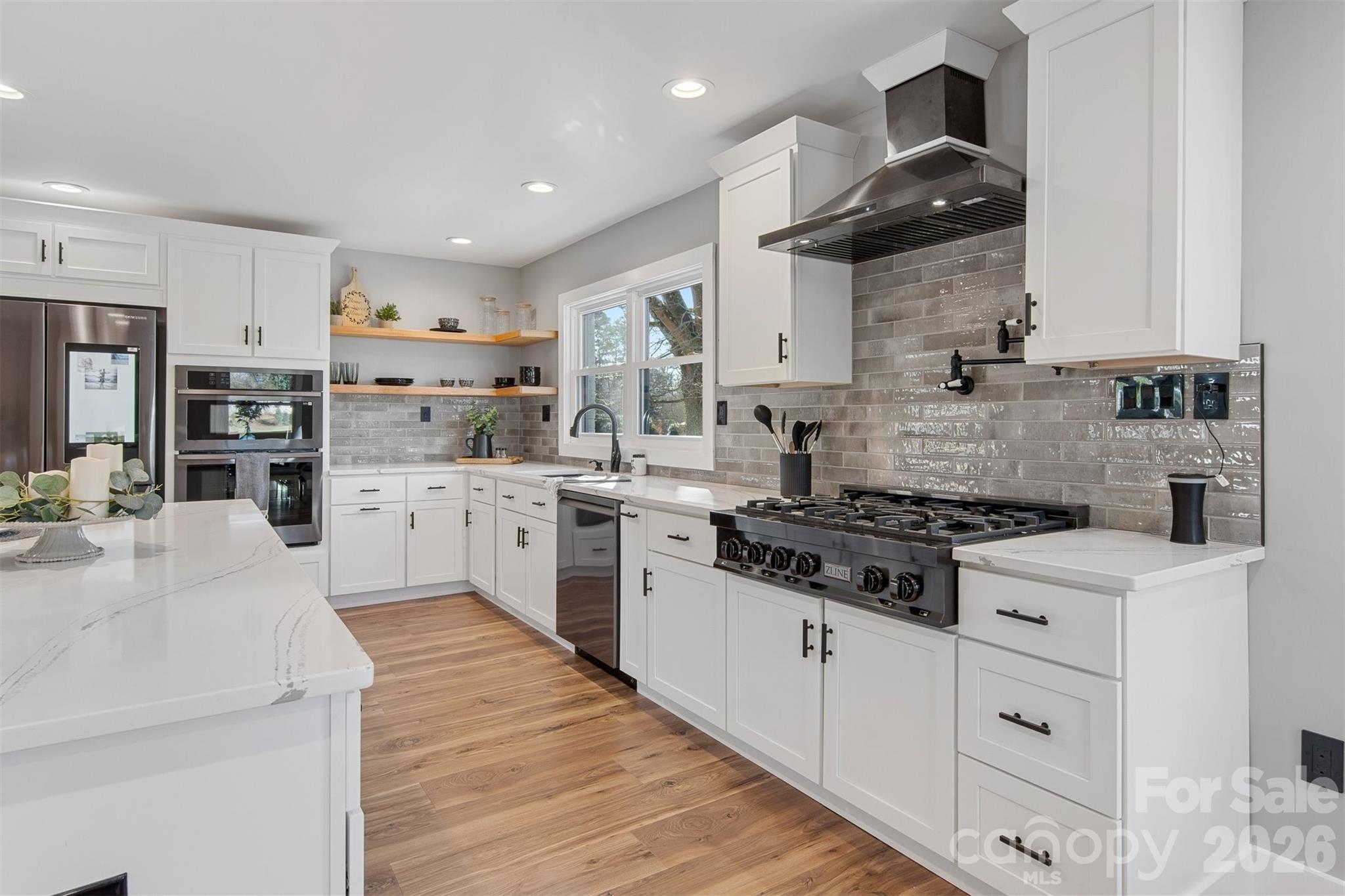1206 9th Street Northwest Hickory, NC 28601 - Photo 12 of 40 a kitchen with stainless steel appliances a sink stove and cabinets