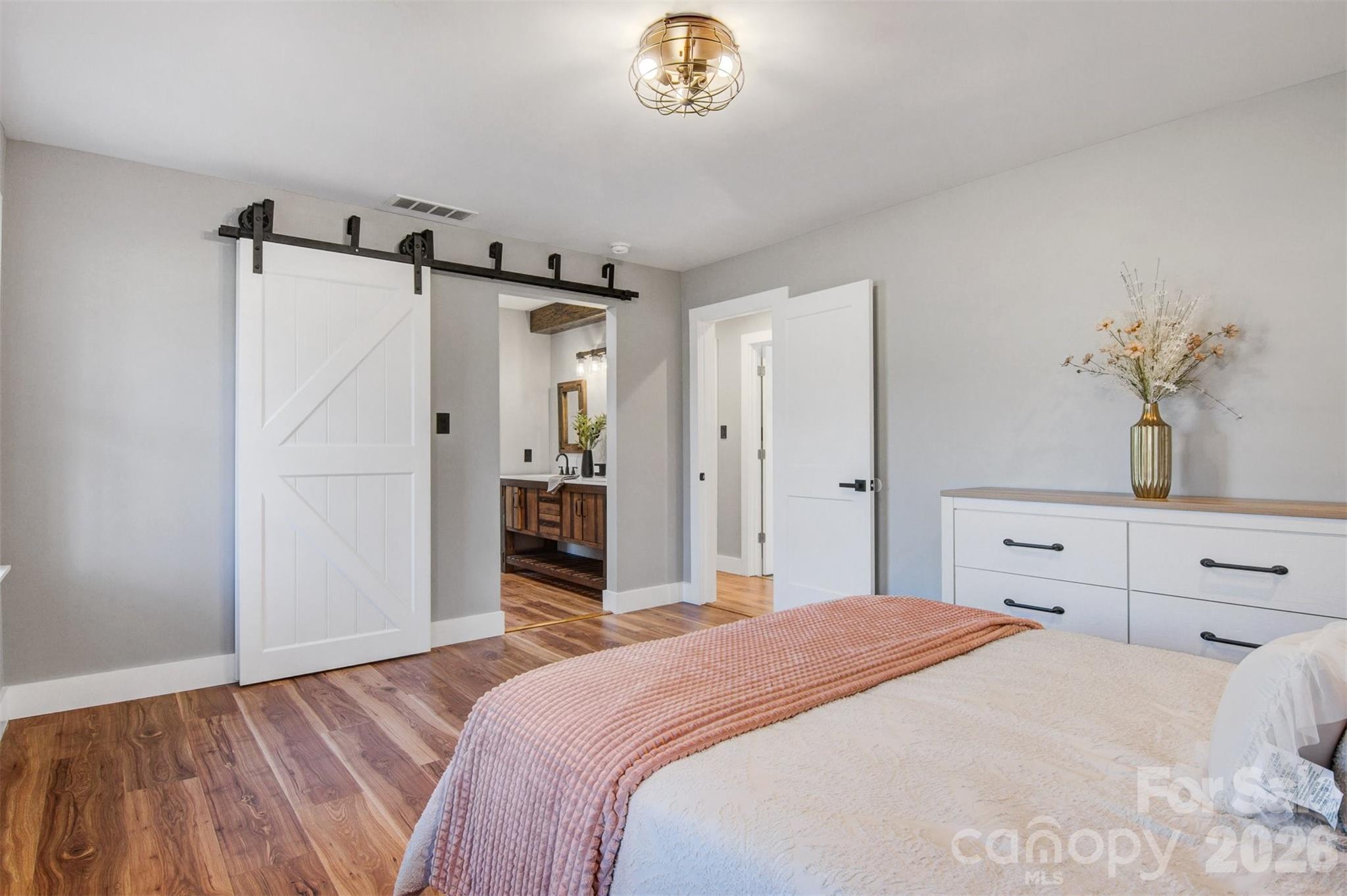 1206 9th Street Northwest Hickory, NC 28601 - Photo 18 of 40 a bedroom with a bed and a chandelier