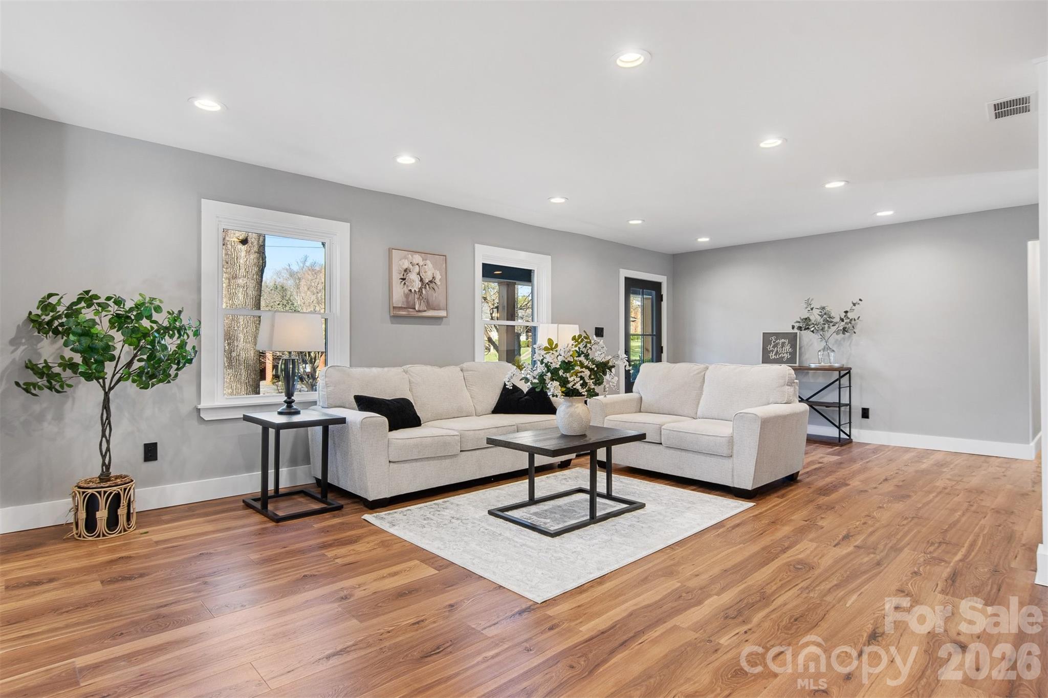 1206 9th Street Northwest Hickory, NC 28601 - Photo 2 of 40 a living room with furniture and a potted plant
