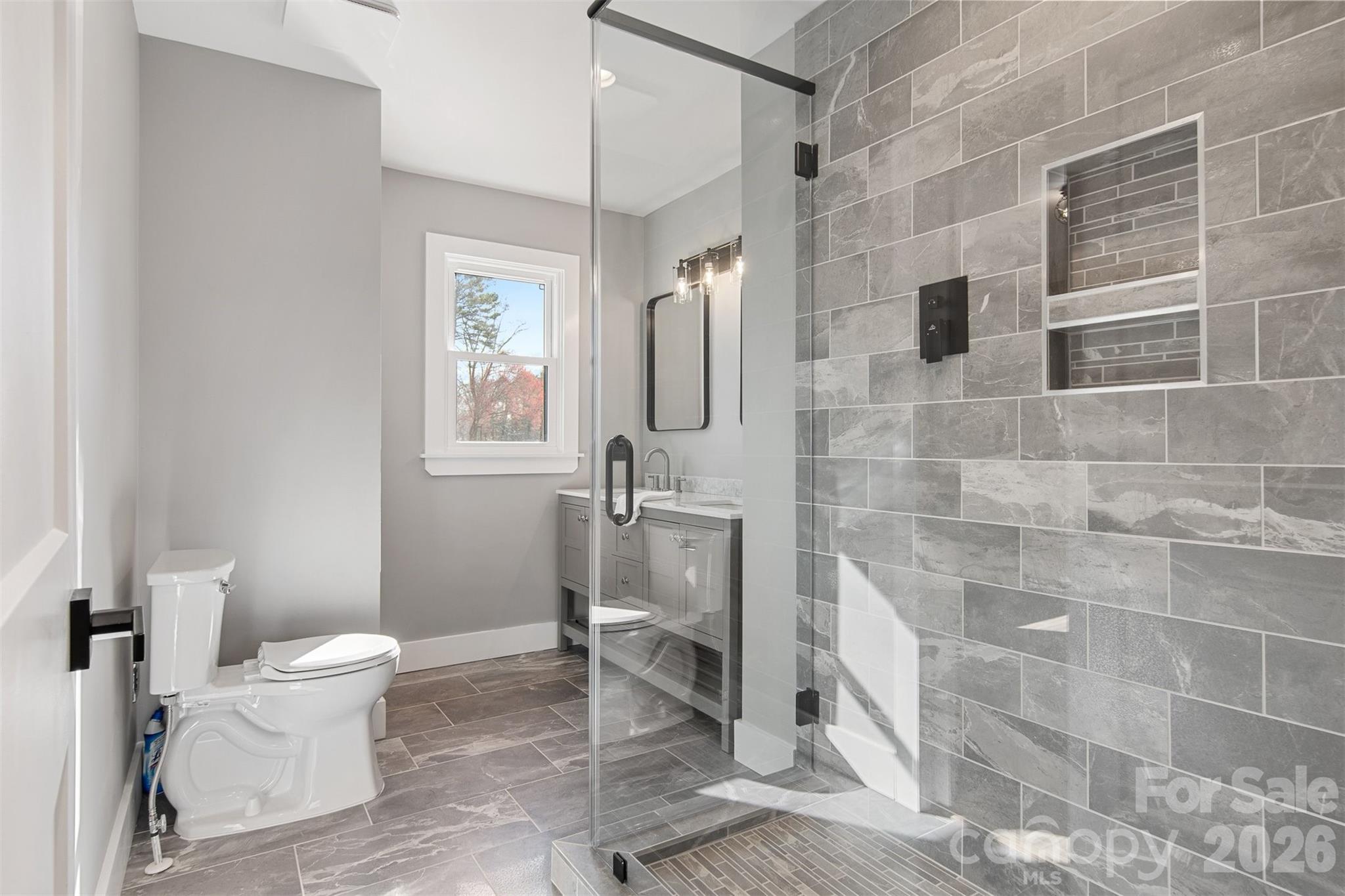 1206 9th Street Northwest Hickory, NC 28601 - Photo 22 of 40 a bathroom with a toilet and a shower